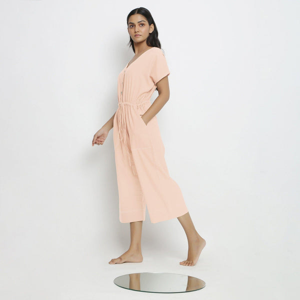 Left View of a Model wearing Powder Pink Vegetable Dyed Button-Down Jumpsuit