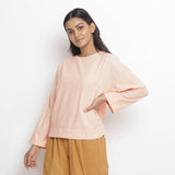 Front View of a Model wearing Powder Pink Vegetable Dyed Cotton Loose Fit Tie Neck Top