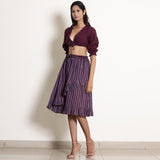 Left View of a Model wearing Reversible Plunge Neck Top and Wrap Skirt Set