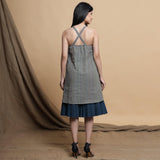 Back View of a Model wearing Reversible Pleated Knee Length Dress