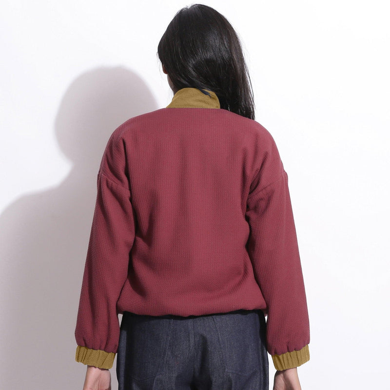 Back View of a Model wearing Reversible Red Green Waffle Bomber Jacket