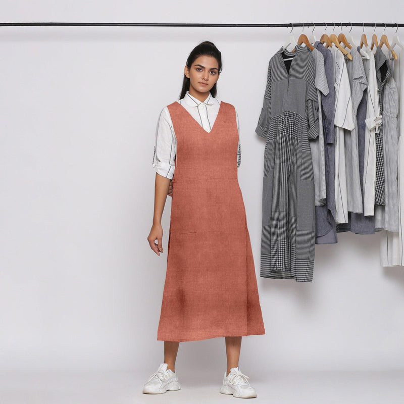 Front View of a Model wearing Rust 100% Linen V-Neck Midi Pinafore Dress