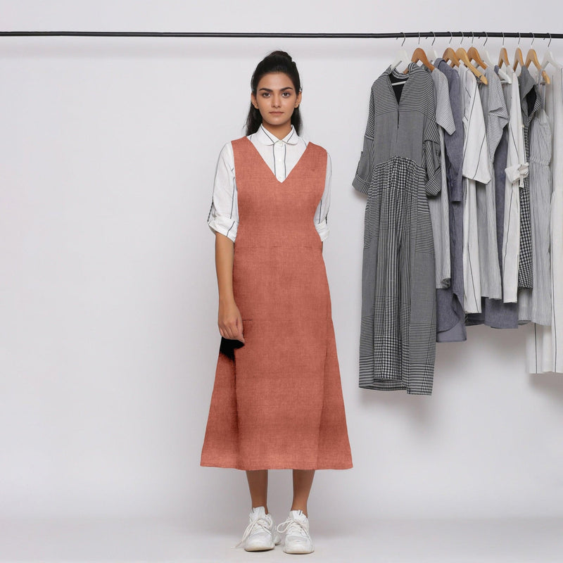 Front View of a Model wearing Rust 100% Linen V-Neck Midi Pinafore Dress