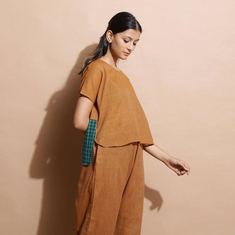 Right View of a Model wearing Rust Cotton Muslin Lined High-Low Top