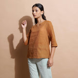 Left View of a Model wearing Rust Cotton Muslin Solid Handspun Top