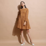 Front View of a Model wearing Rust Handspun Solid Gathered Dress