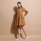 Left View of a Model wearing Rust Handspun Solid Gathered Dress