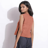 Left View of a Model wearing Rust Sandstone 100% Linen Button-Down Short Top