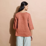 Back View of a Model wearing Rust Sandstone 100% Linen Split-Neck Tunic Top