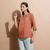 Left View of a Model wearing Rust Sandstone 100% Linen Split-Neck Tunic Top