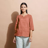 Front View of a Model wearing Rust Sandstone 100% Linen Split-Neck Tunic Top