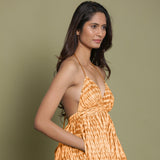 Right View of a Model wearing Rust Shibori Halter Neck Gathered Dress