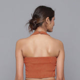 Back View of a Model wearing Sunset Rust Corduroy Halter Neck Top