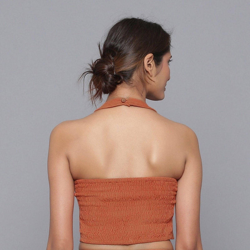 Back View of a Model wearing Sunset Rust Corduroy Halter Neck Top