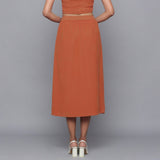 Back View of a Model wearing Sunset Rust Button-Down Midi Skirt