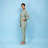 Left View of a Model wearing Sage Green Block Printed 100% Cotton Straight Jumpsuit