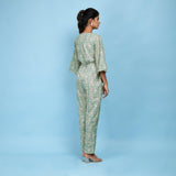 Back View of a Model wearing Sage Green Block Printed 100% Cotton Straight Jumpsuit