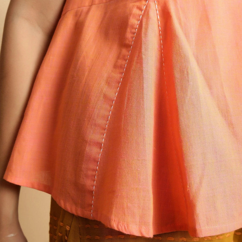 Close View of a Model wearing Salmon Pink Hand-Embroidered Flared Top