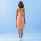 Back View of a Model wearing Salmon Pink Handspun Cotton Strap Slit Dress