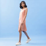 Left View of a Model wearing Salmon Pink Handspun Cotton Strap Slit Dress