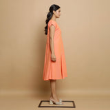 Right View of a Model wearing Salmon Pink Cotton Button-Down Dress