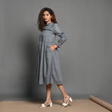 Left View of a Model wearing Grey Handspun Cotton Frilled Peasant Dress