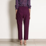 Back View of a Model wearing Warm Berry Wine Frilled Waist Tapered Pant