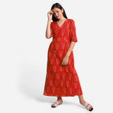 Front View of a Model wearing Sunset Orange Dabu Print 100% Cotton Wrap Dress