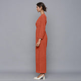 Left View of a Model wearing Sunset Rust Corduroy Comfy Jumpsuit