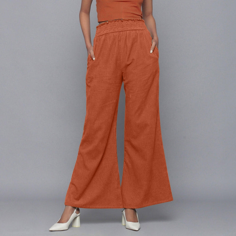 Front View of a Model wearing Sunset Rust Corduroy Striped Bootcut Pant