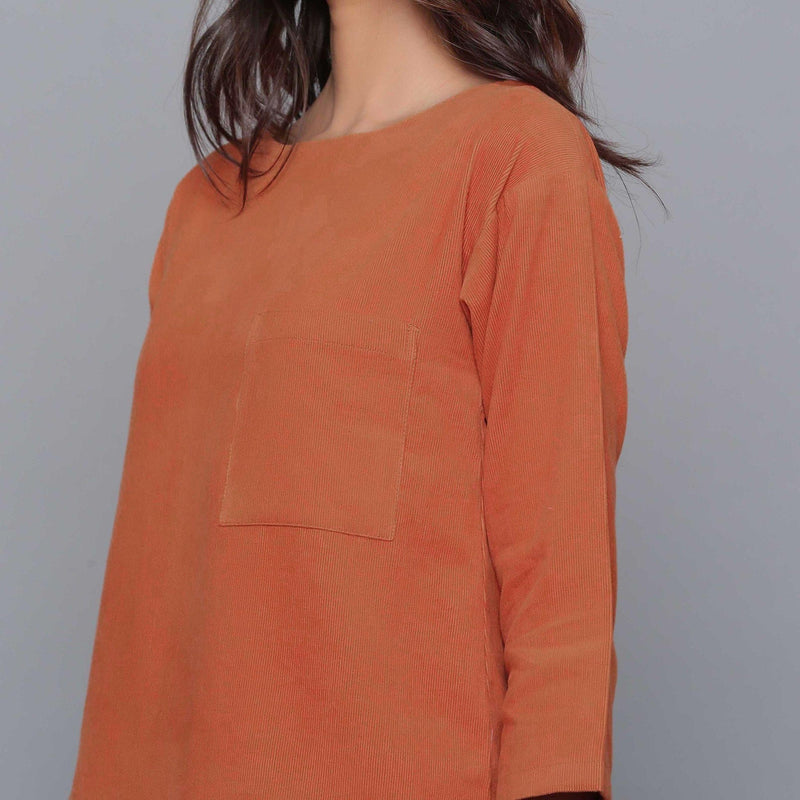 Front Detail of a Model wearing Sunset Rust Corduroy Drop Shoulder Top