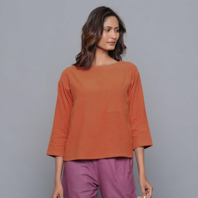 Front View of a Model wearing Sunset Rust Corduroy Drop Shoulder Top