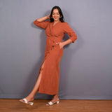 Left View of a Model wearing Sunset Rust Warm Cotton Corduroy Front Slit Maxi Dress