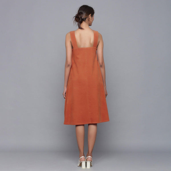 Back View of a Model wearing Sunset Rust Corduroy Flared Dress