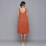 Back View of a Model wearing Sunset Rust Corduroy Flared Dress