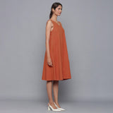 Right View of a Model wearing Sunset Rust Corduroy Flared Dress