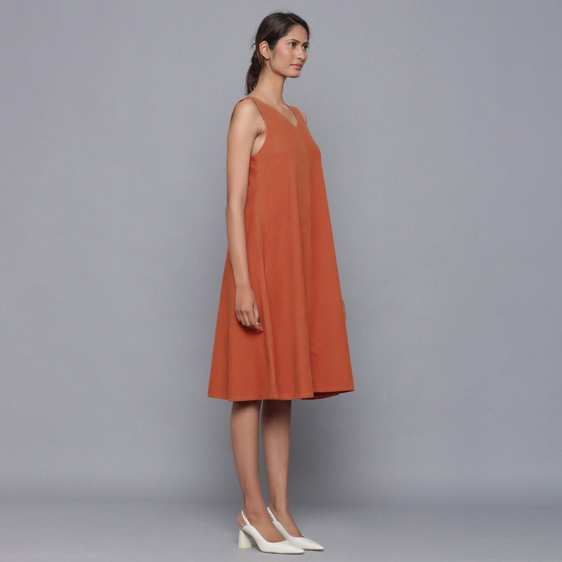 Right View of a Model wearing Sunset Rust Corduroy Flared Dress