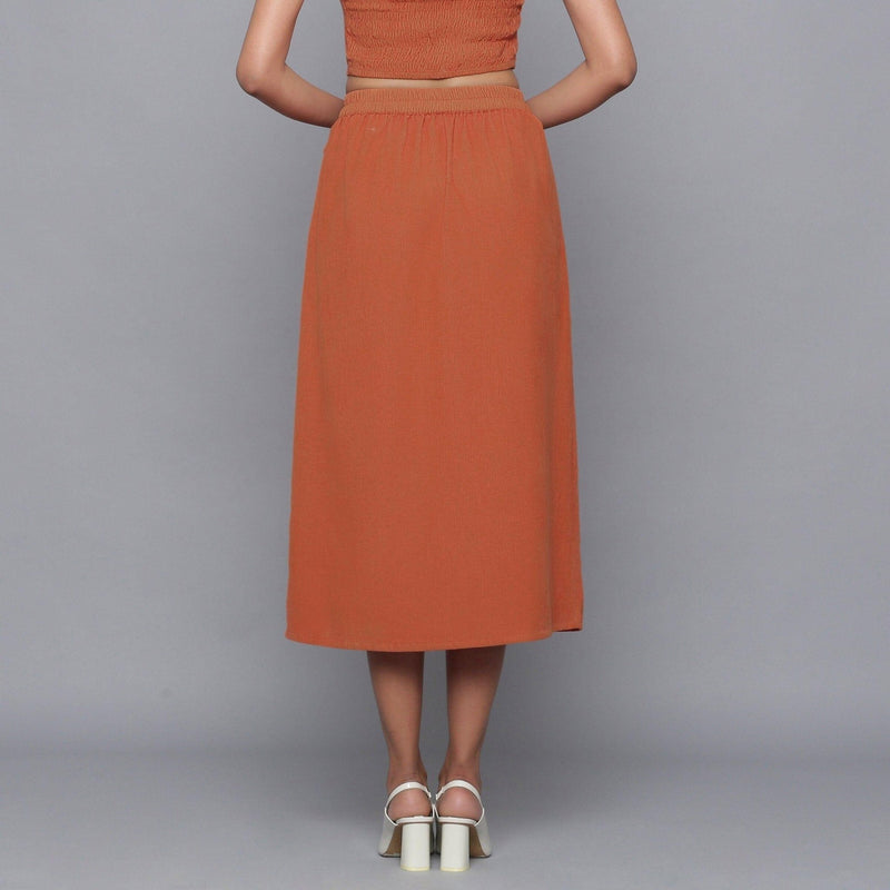 Back View of a Model wearing Sunset Rust Button-Down Midi Skirt