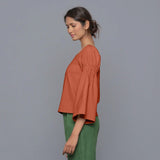 Left View of a Model Sunset Rust Pistachio Corduroy Bohemian Top