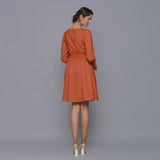 Back View of a Model wearing Sunset Rust V-Neck Corduroy Dress