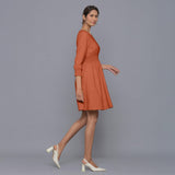 Right View of a Model wearing Sunset Rust V-Neck Corduroy Dress