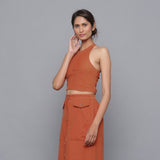 Left View of a Model wearing Sunset Rust Corduroy Halter Neck Top