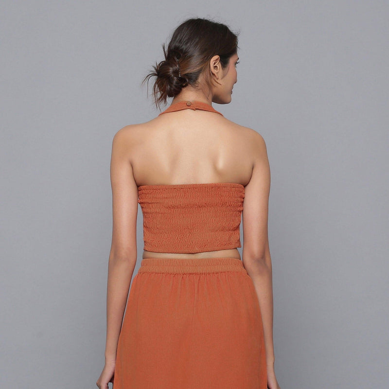 Back View of a Model wearing Sunset Rust Corduroy Halter Neck Top