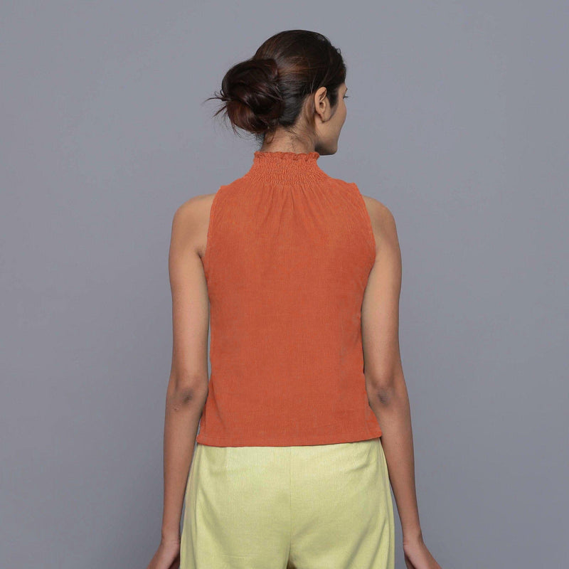 Back View of a Model wearing Sunset Rust Cotton Corduroy High Neck Top