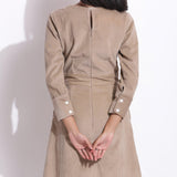 Back Detail of a Model wearing Cotton Corduroy Taupe Beige Surplice Dress