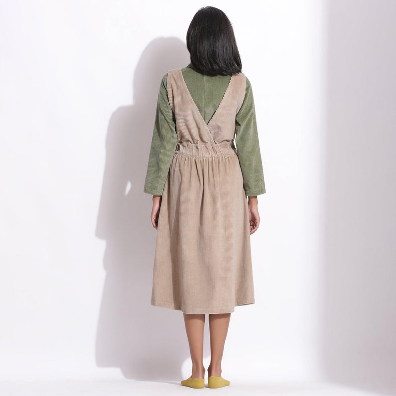 Back View of a Model wearing Taupe Beige Cotton Corduroy Pinafore Dress