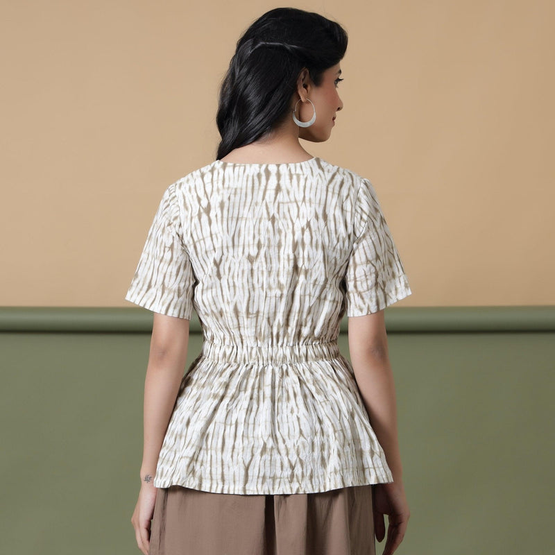 Back View of a Model wearing Shibori Button-Down Peplum Top