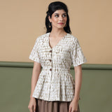 Front View of a Model wearing Shibori Button-Down Peplum Top