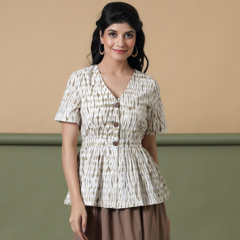 Front View of a Model wearing Shibori Button-Down Peplum Top