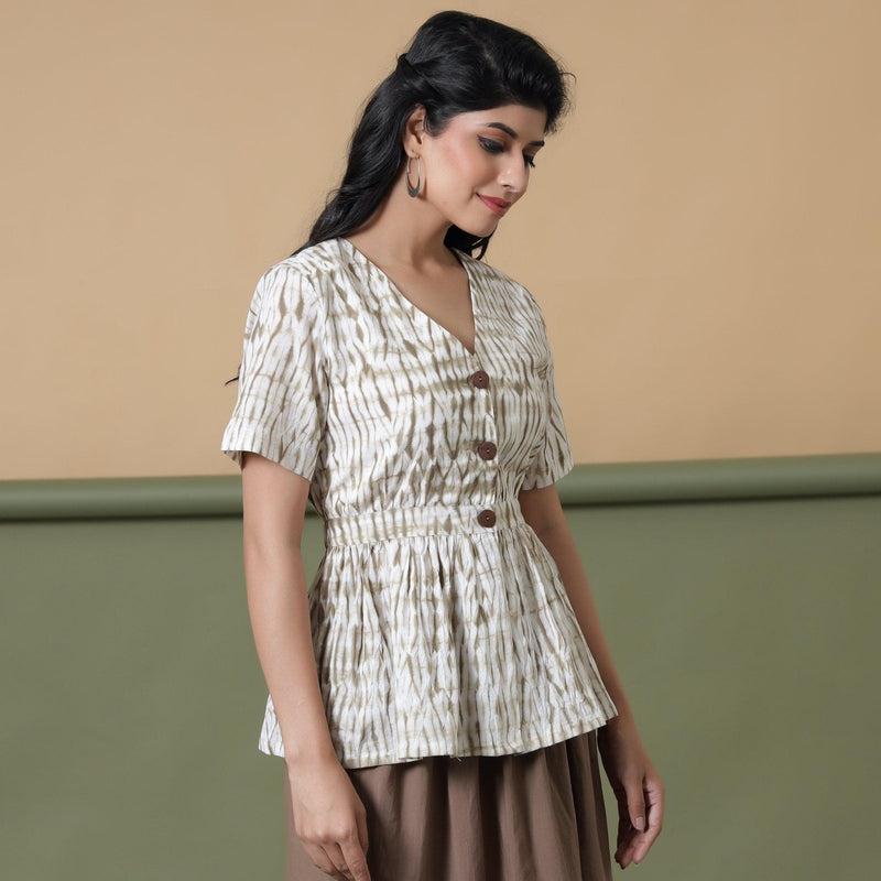 Right View of a Model wearing Shibori Button-Down Peplum Top